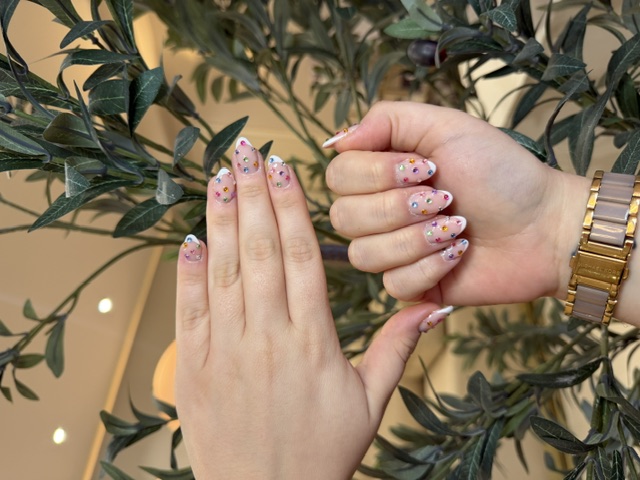 Pink manicure with colourful jewel embellishments